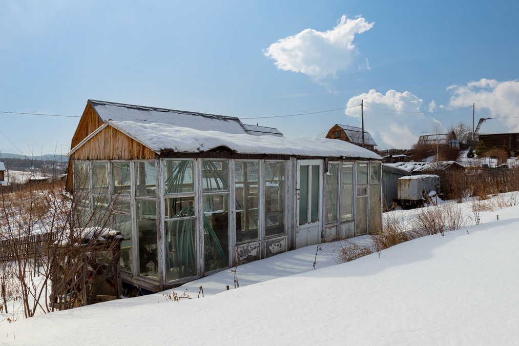 Homemade greenhouse in snow in winter